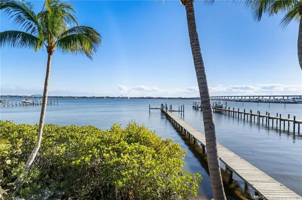 a view of a hallway with wooden floor and windows