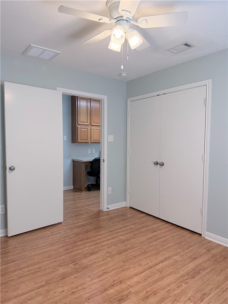 1029 Fallbrook Loop College Station, TX 77845 - Photo 21 of 34 an empty room with wooden floor chandelier fan and windows