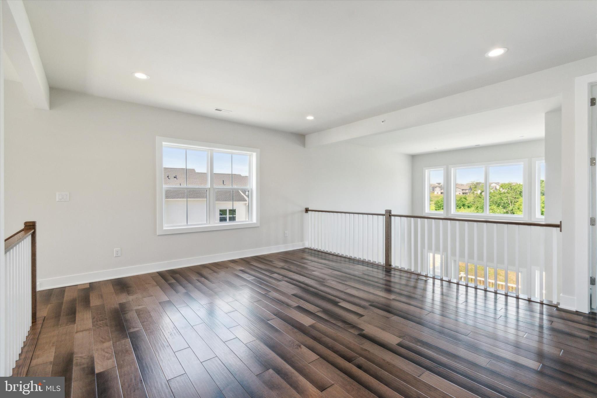 573 Trifecta Road, Unit 313 Downingtown, PA 19335 - Photo 14 of 66 a view of an empty room with wooden floor and a window