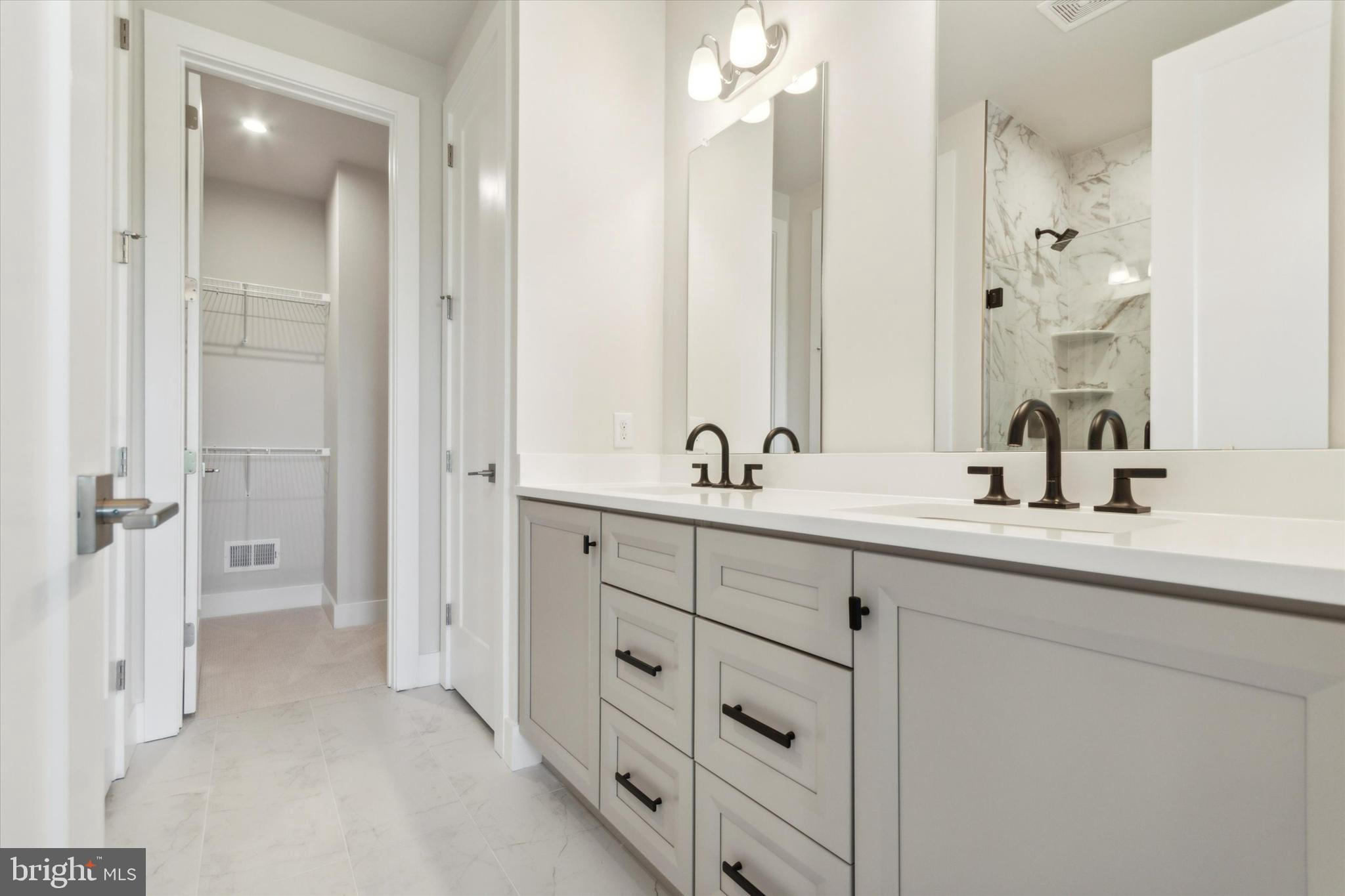 573 Trifecta Road, Unit 313 Downingtown, PA 19335 - Photo 17 of 66 a bathroom with double vanity sinks and a mirror