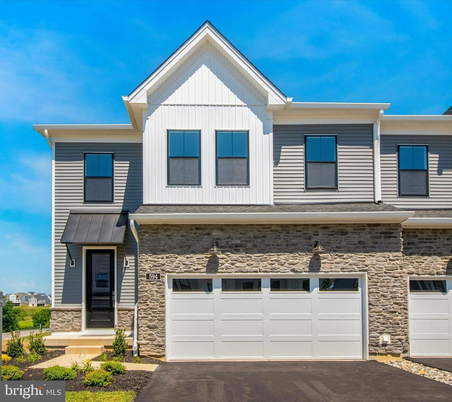 573 Trifecta Road, Unit 313 Downingtown, PA 19335 - Photo 2 of 66 a front view of a house with garden