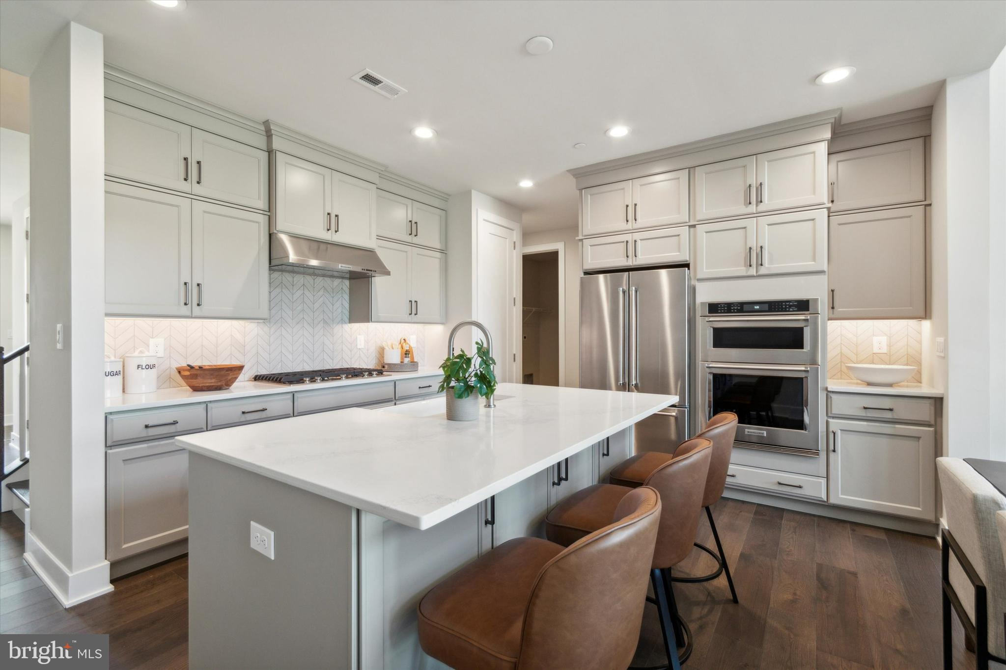 573 Trifecta Road, Unit 313 Downingtown, PA 19335 - Photo 2 of 37 a kitchen with a table chairs refrigerator and cabinets