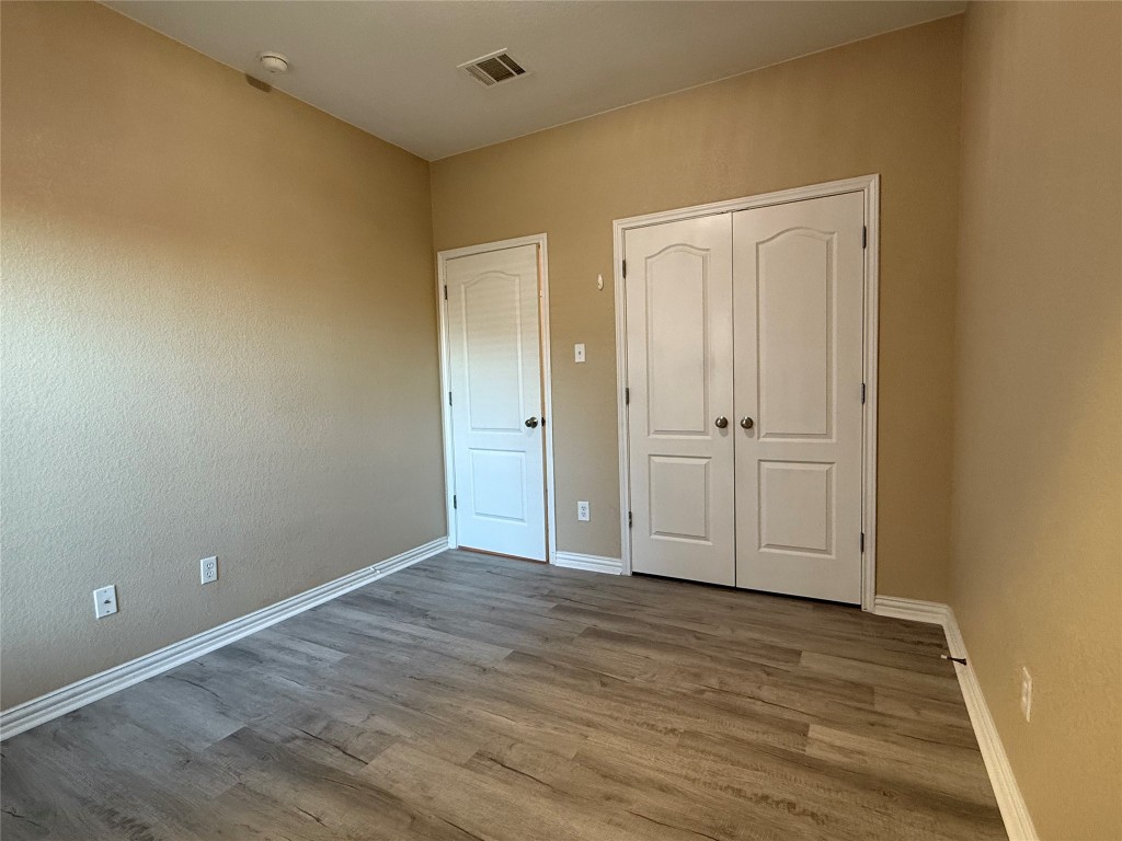 1548 Tonia Loop Round Rock, TX 78665 - Photo 19 of 29 Unfurnished bedroom with wood finished floors and a closet