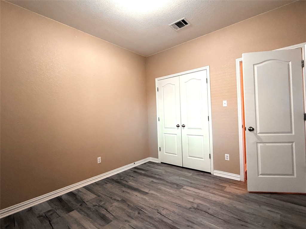1548 Tonia Loop Round Rock, TX 78665 - Photo 22 of 29 a view of an empty room with wooden floor and a window