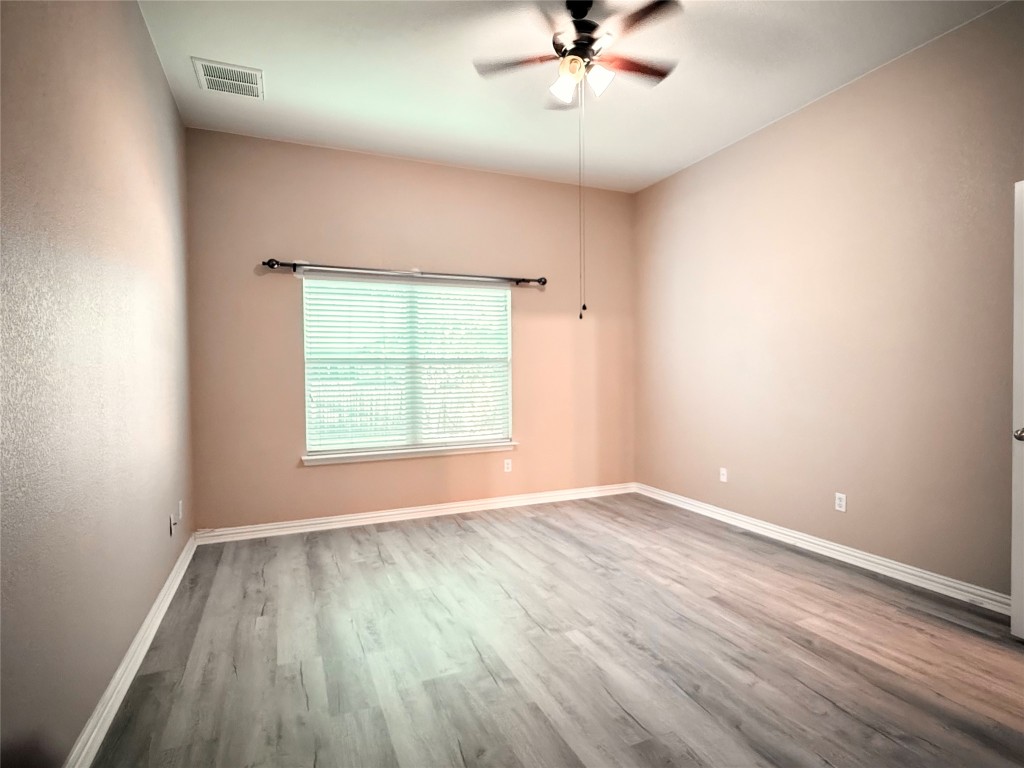 1548 Tonia Loop Round Rock, TX 78665 - Photo 23 of 29 wooden floor in an empty room with a window