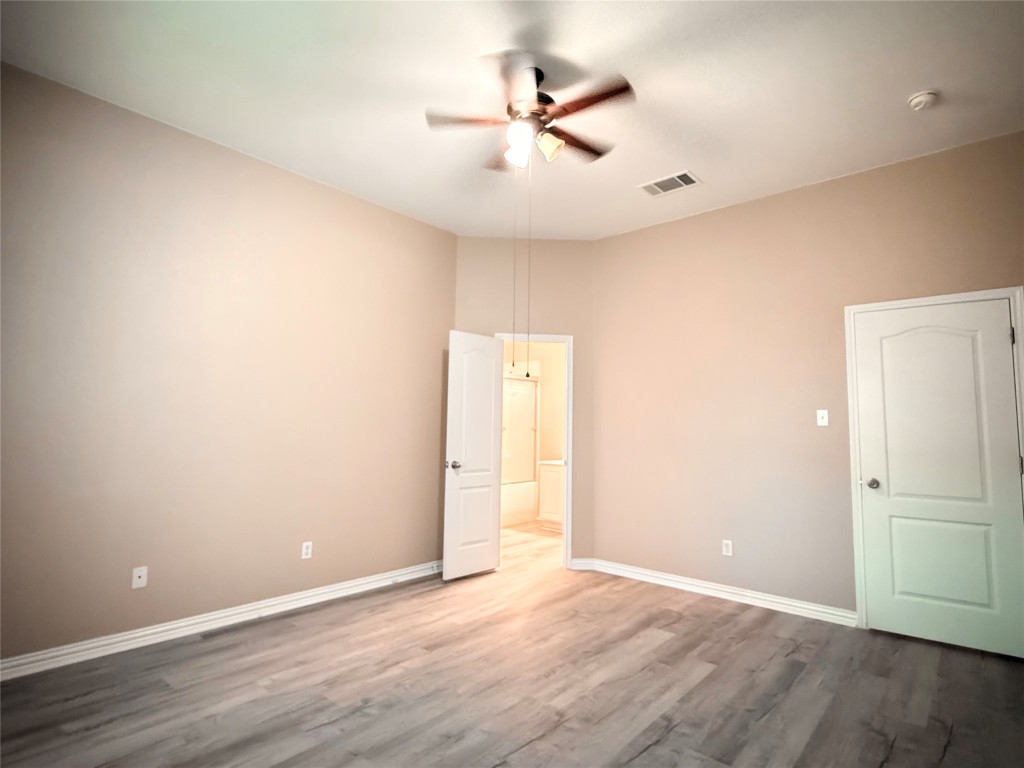 1548 Tonia Loop Round Rock, TX 78665 - Photo 24 of 29 an empty room with wooden floor and ceiling fan