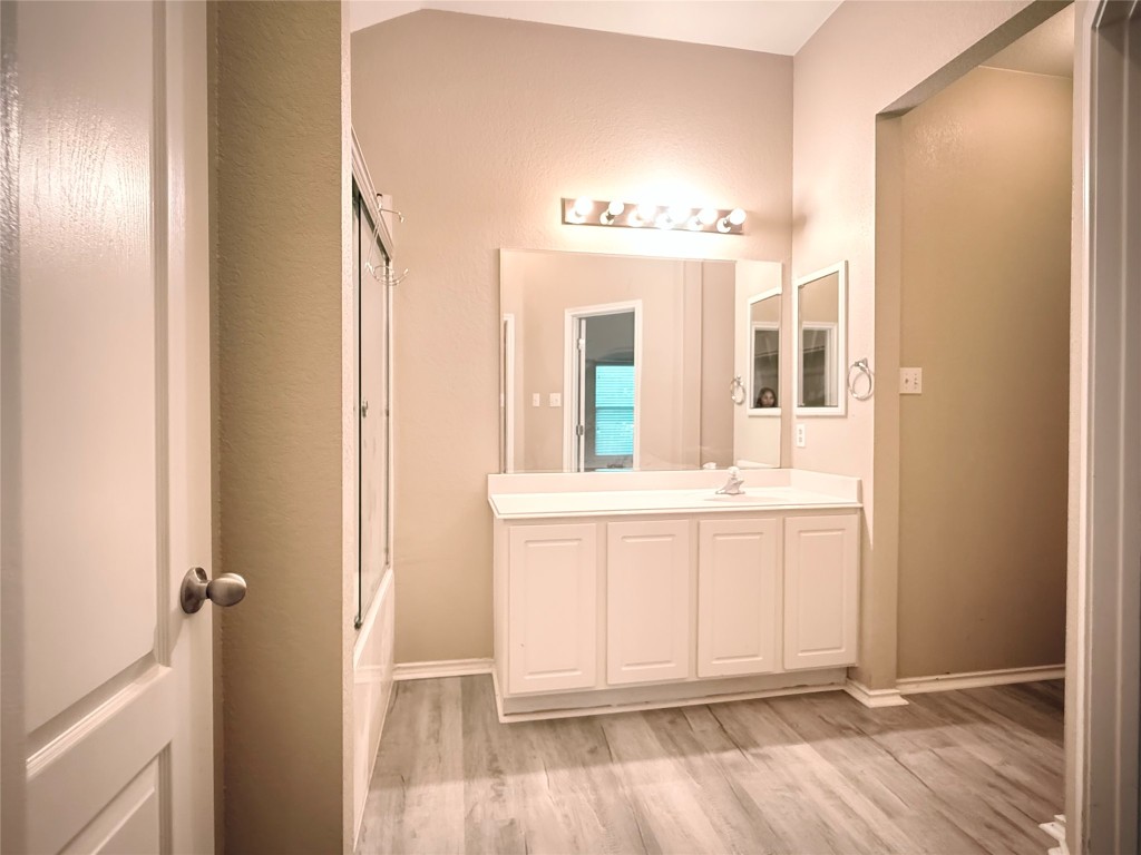 1548 Tonia Loop Round Rock, TX 78665 - Photo 27 of 29 a bathroom with a granite countertop sink and a mirror
