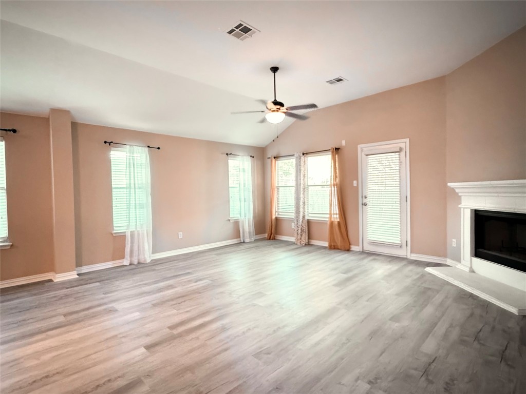 1548 Tonia Loop Round Rock, TX 78665 - Photo 7 of 29 a view of an empty room with window and a kitchen