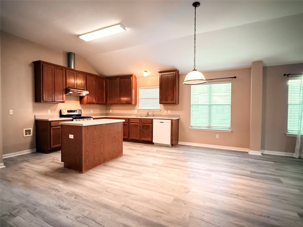 1548 Tonia Loop Round Rock, TX 78665 - Photo 8 of 29 a kitchen with stainless steel appliances granite countertop a stove top oven a sink dishwasher and a microwave oven with cabinets