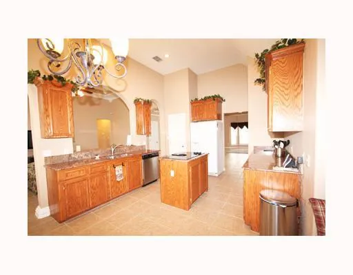 a open kitchen with cabinets a sink and stainless steel appliances