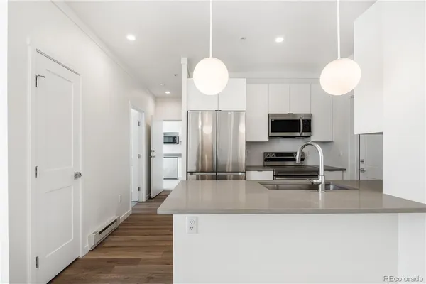 a kitchen with cabinets and stainless steel appliances