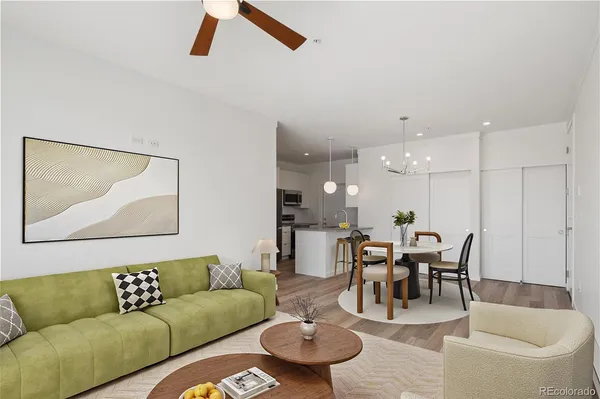 a living room with furniture and kitchen view