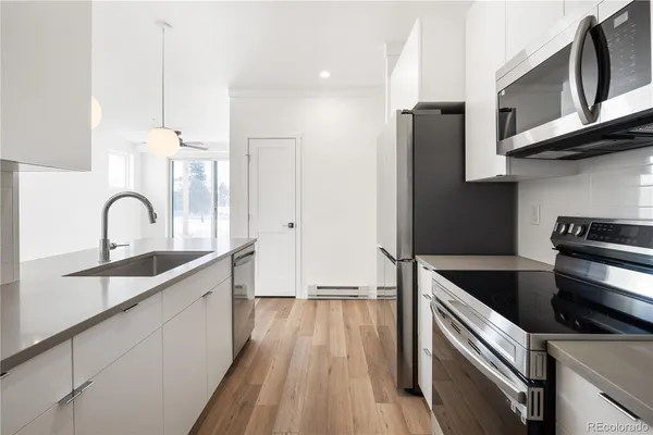 a kitchen with stainless steel appliances granite countertop a sink and a stove