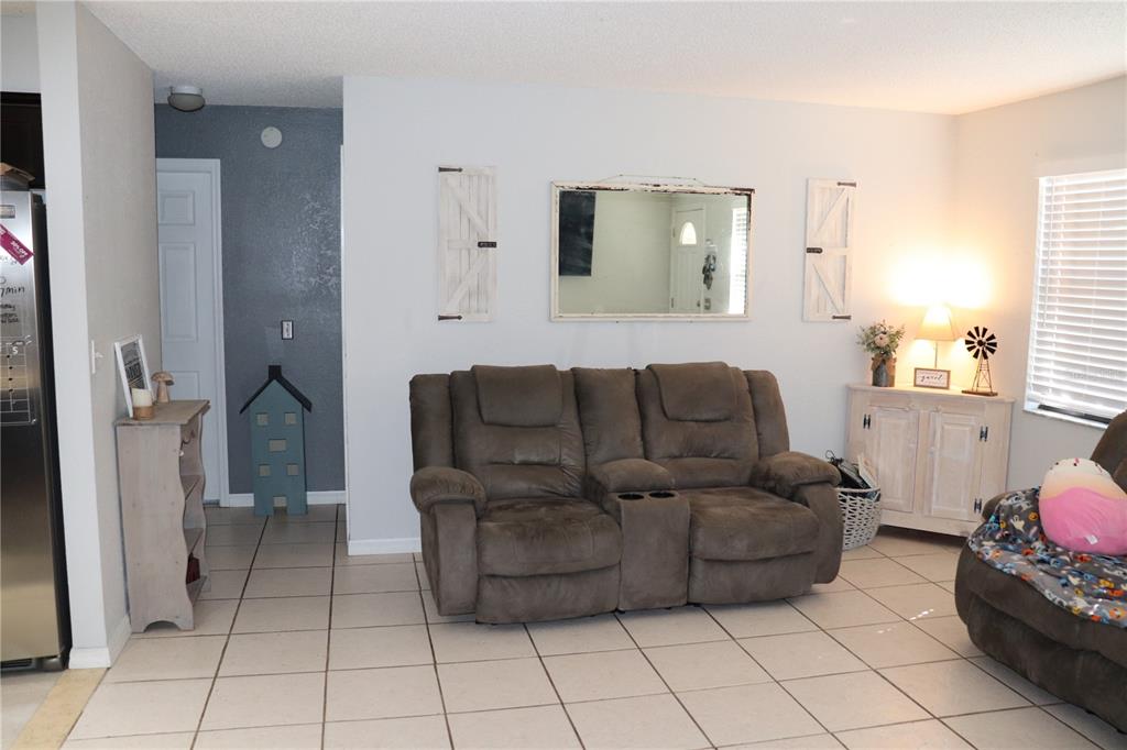 12387 Seagate Street Spring Hill, FL 34609 - Photo 12 of 51 a living room with furniture and a window