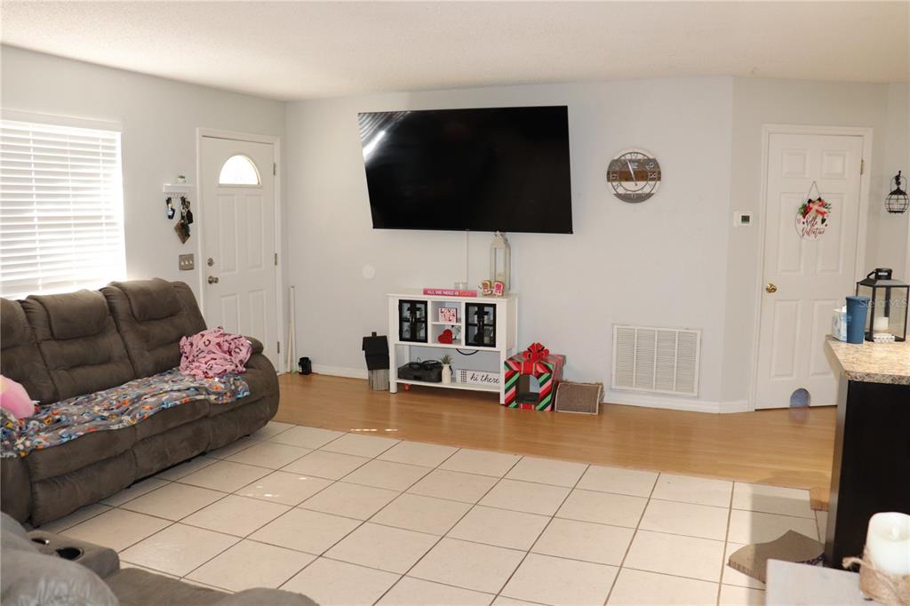 12387 Seagate Street Spring Hill, FL 34609 - Photo 13 of 51 a living room with furniture and a flat screen tv