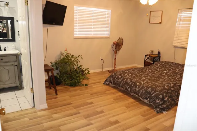 a bedroom with a bed and flat screen tv