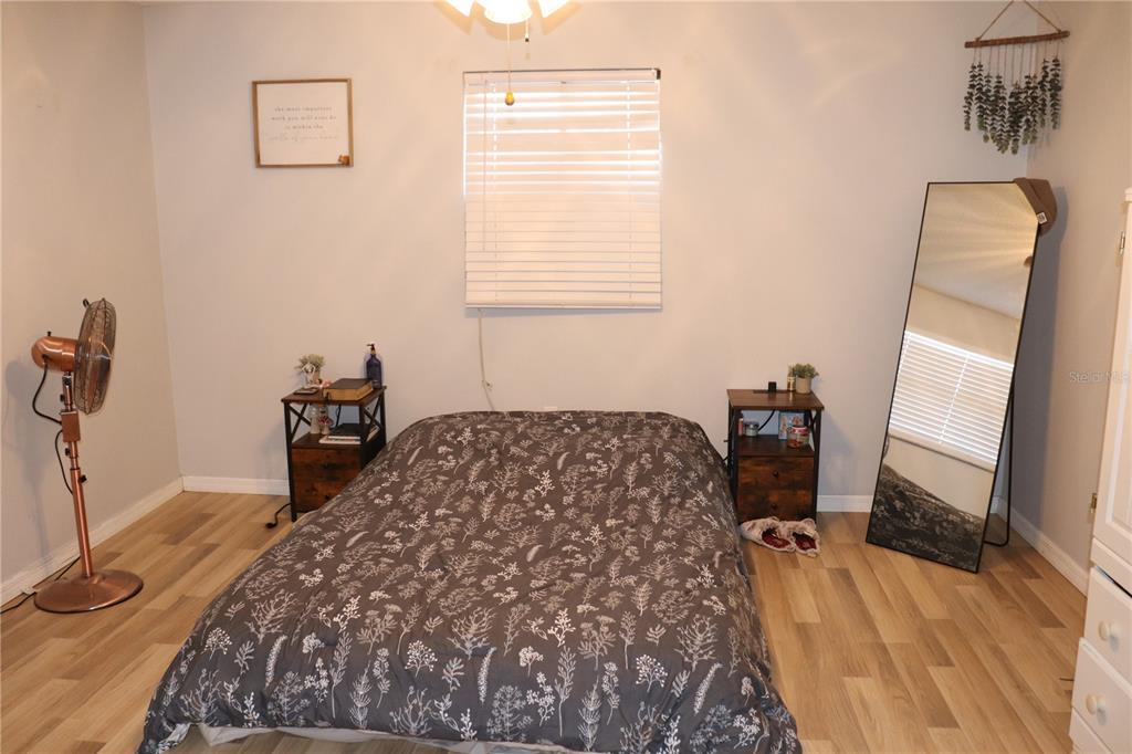 12387 Seagate Street Spring Hill, FL 34609 - Photo 15 of 51 a bedroom with a bed and a table in it