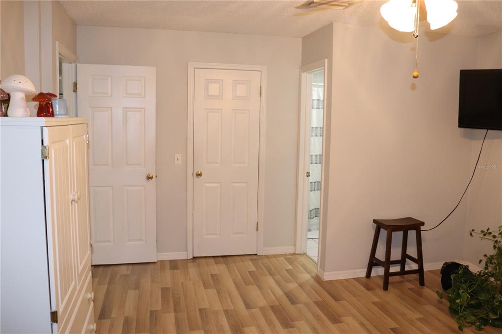 12387 Seagate Street Spring Hill, FL 34609 - Photo 16 of 51 a view of empty room with wooden floor