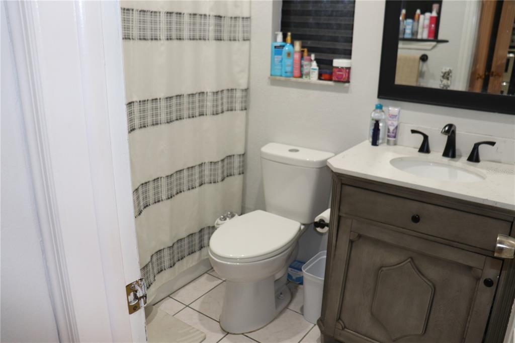 12387 Seagate Street Spring Hill, FL 34609 - Photo 17 of 51 a bathroom with a toilet and a sink