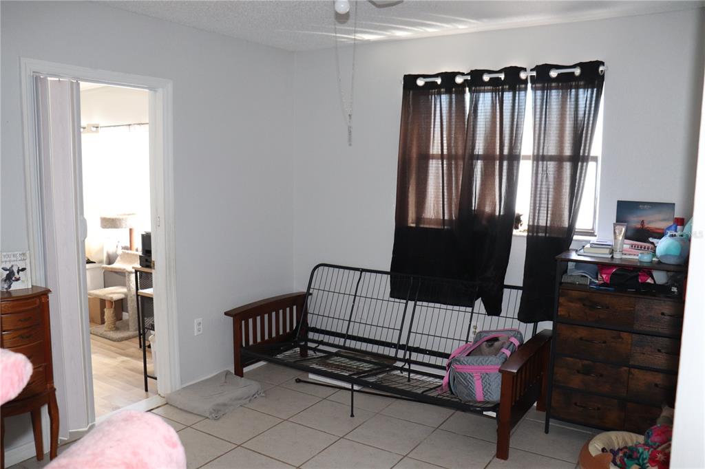 12387 Seagate Street Spring Hill, FL 34609 - Photo 21 of 51 a bedroom with furniture and a window