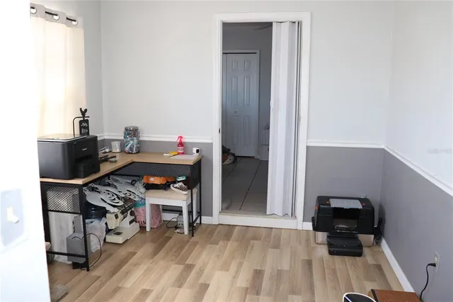 a view of a workspace with furniture and wooden floor
