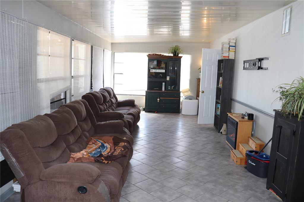 12387 Seagate Street Spring Hill, FL 34609 - Photo 29 of 51 a living room with furniture and a flat screen tv