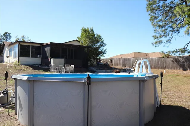a view of a white house with a snow on the road