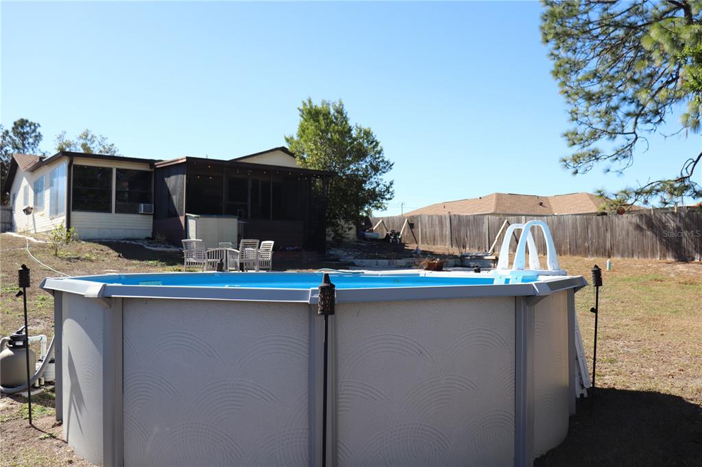 12387 Seagate Street Spring Hill, FL 34609 - Photo 38 of 51 a view of a kitchen with a sink and dishwasher a barbeque with potted plants