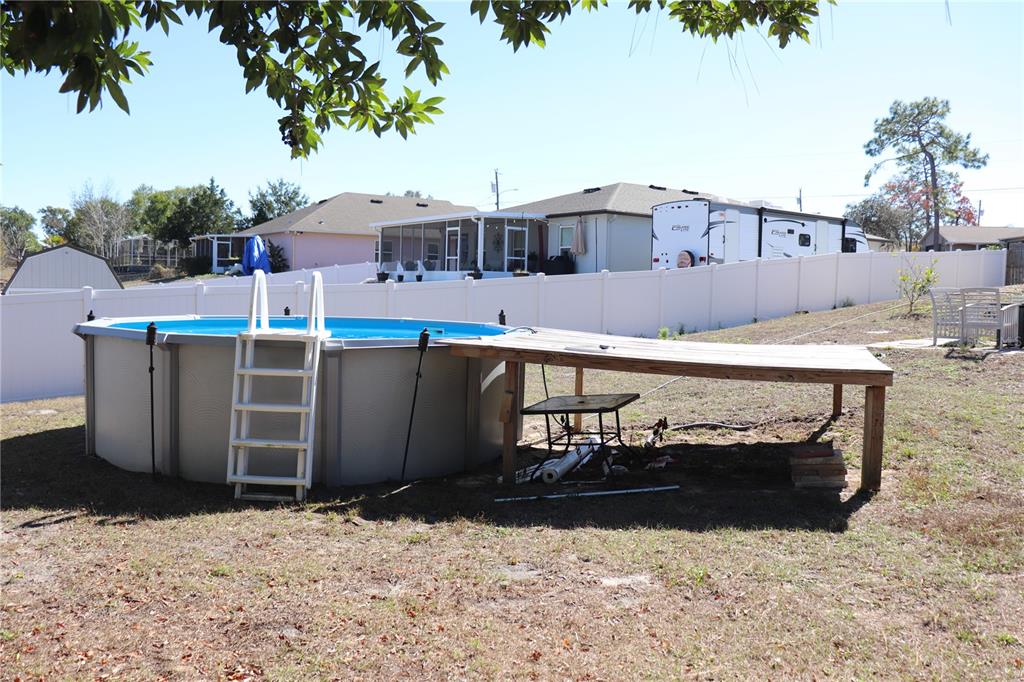 12387 Seagate Street Spring Hill, FL 34609 - Photo 40 of 51 a view of a house with a yard