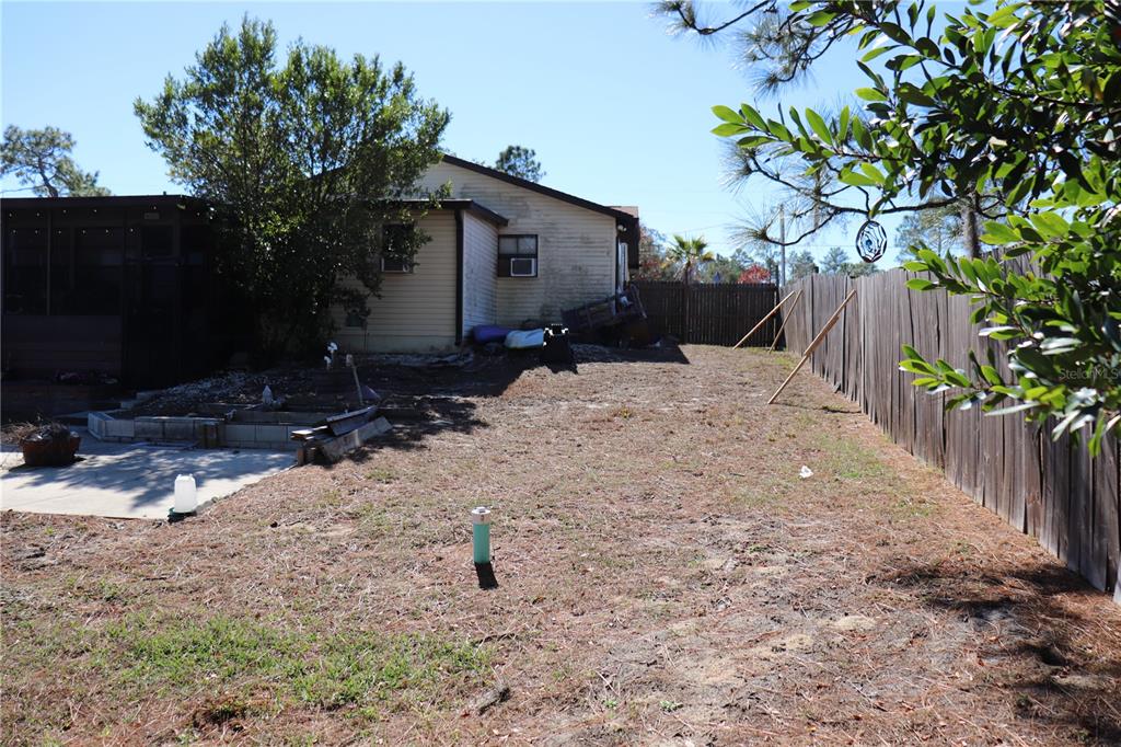 12387 Seagate Street Spring Hill, FL 34609 - Photo 45 of 51 a backyard of a house with lots of green space