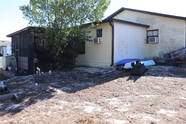 a view of a backyard with wooden fence