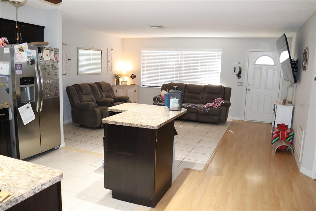 12387 Seagate Street Spring Hill, FL 34609 - Photo 9 of 51 a living room with furniture and a flat screen tv