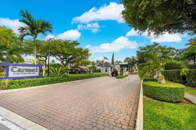 a view of a house with a yard and potted plants