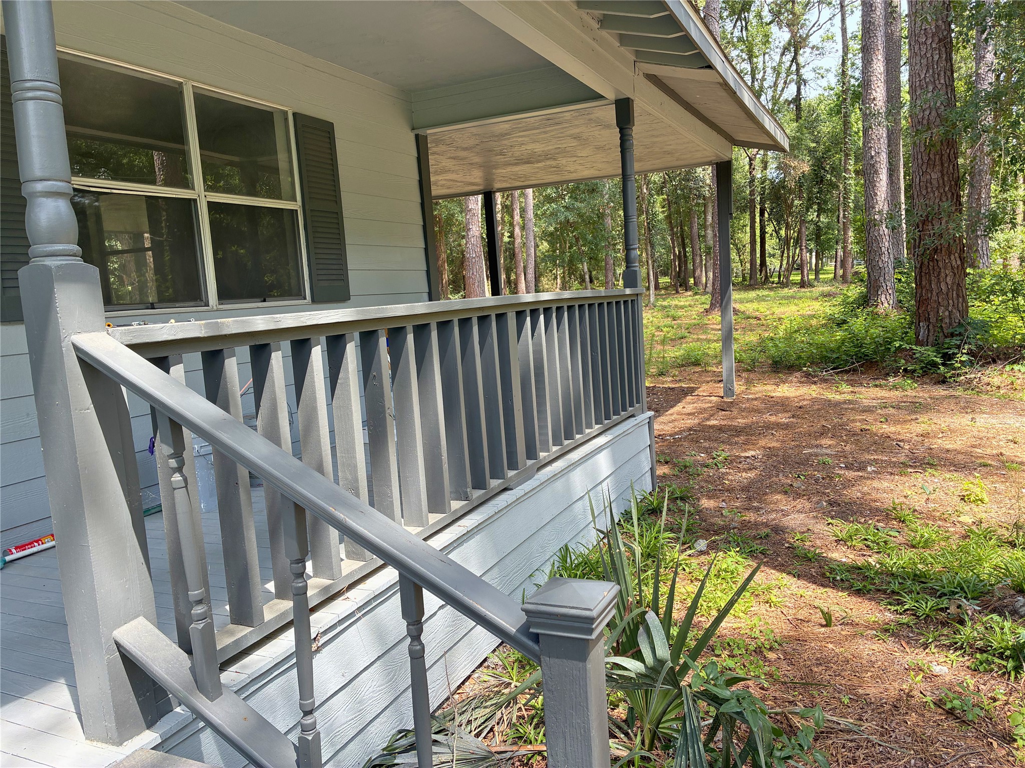 117 Amanda Street Conroe, TX 77304 - Photo 6 of 35 a view of deck with a large trees and wooden fence