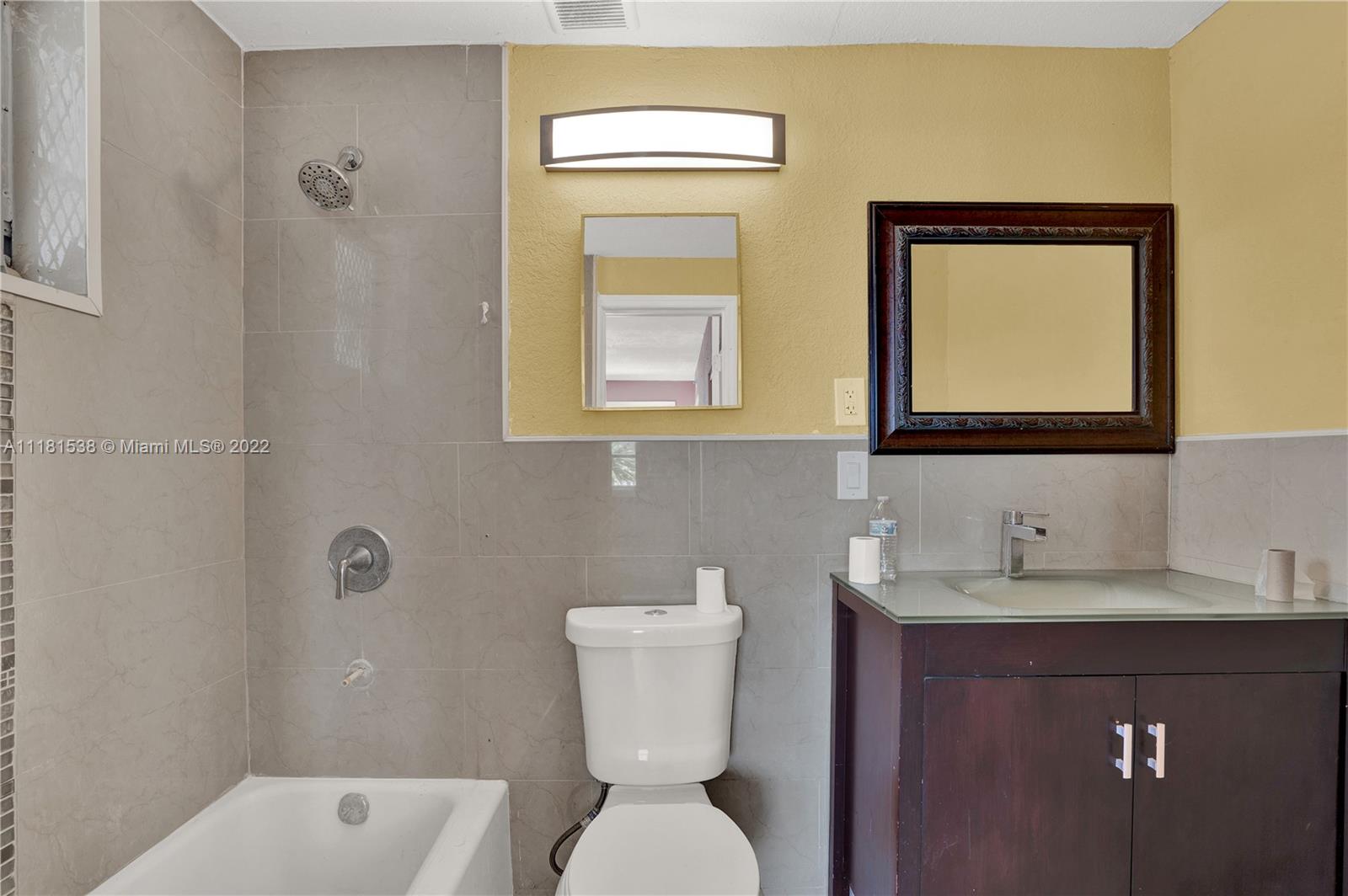 832 West 4th Street Riviera Beach, FL 33404 - Photo 20 of 21 a bathroom with a toilet sink and mirror