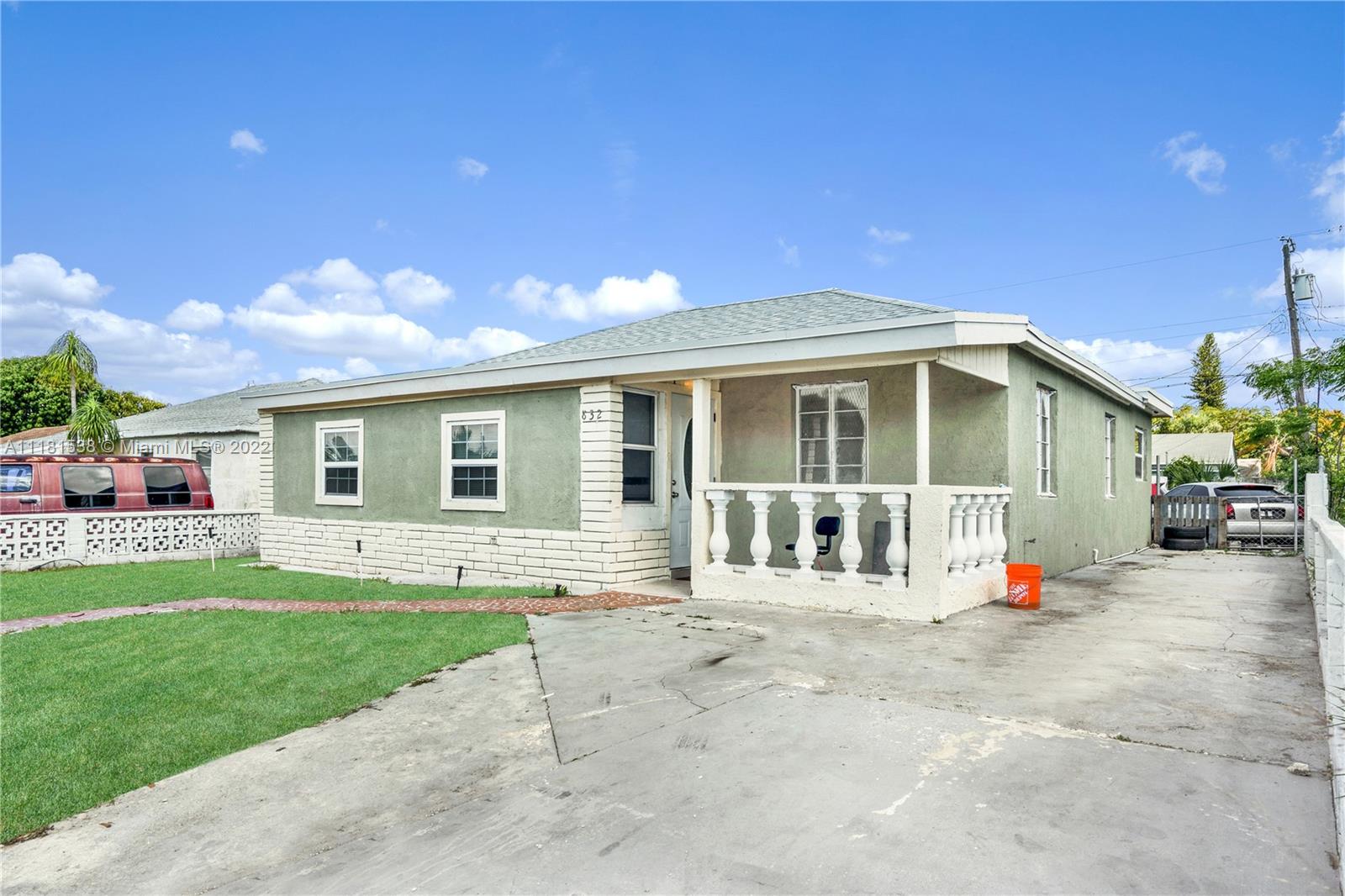832 West 4th Street Riviera Beach, FL 33404 - Photo 2 of 21 a front view of a house with a yard