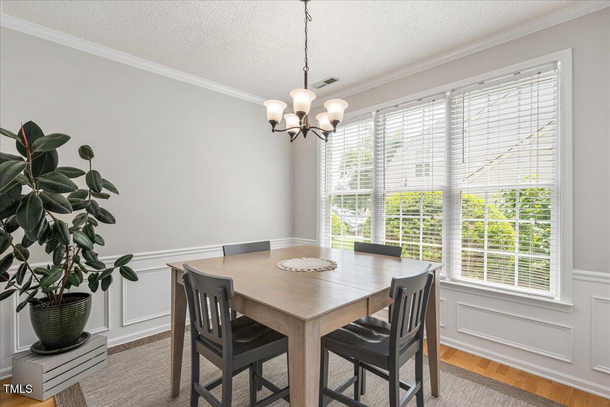 4524 Drewbridge Way Raleigh, NC 27604 - Photo 13 of 29 a view of a dining room with furniture window and wooden floor