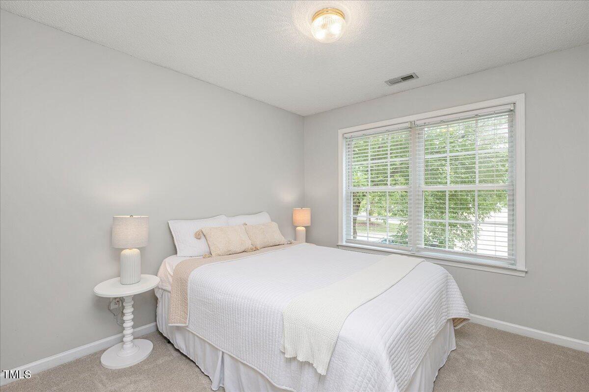 4524 Drewbridge Way Raleigh, NC 27604 - Photo 21 of 29 a bedroom with a bed and a window