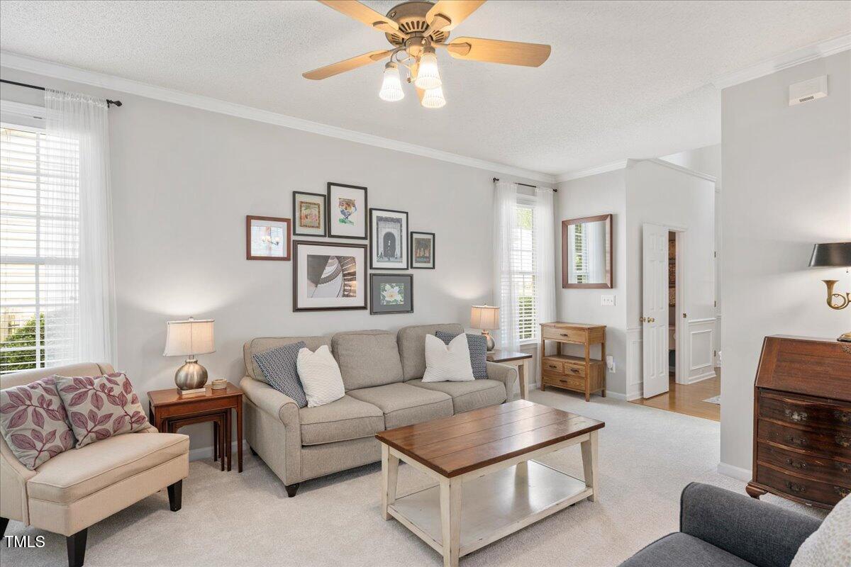 4524 Drewbridge Way Raleigh, NC 27604 - Photo 5 of 29 a living room with furniture and a chandelier