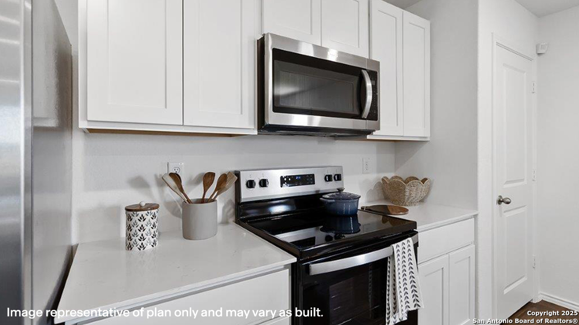 12602 Desert Fox Converse, TX 78109 - Photo 14 of 49 a kitchen with a stove and a microwave