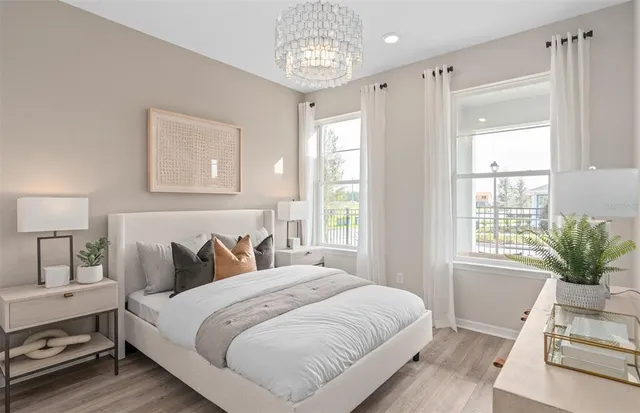 a bedroom with a bed and a large mirror