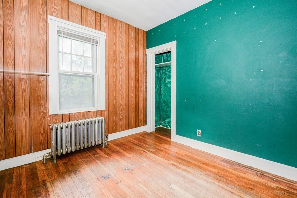 35 Reservation Road Milton, MA 02186 - Photo 8 of 13 an empty room with window and stairs