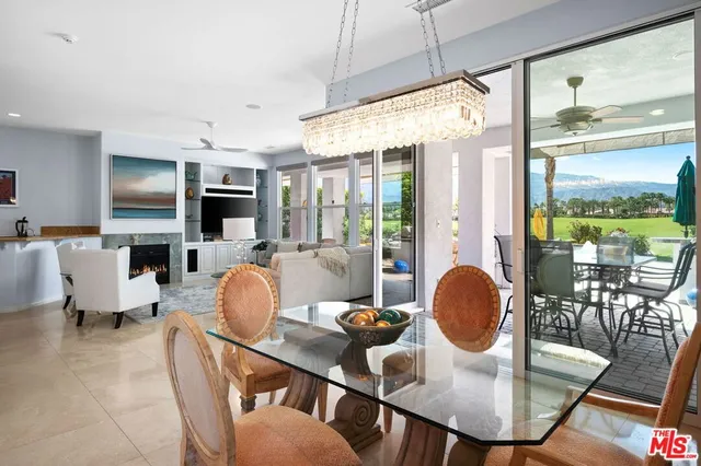 a large kitchen with granite countertop a large counter top stainless steel appliances and cabinets