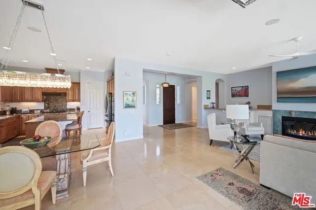 a spacious bedroom with a bed and a chandelier