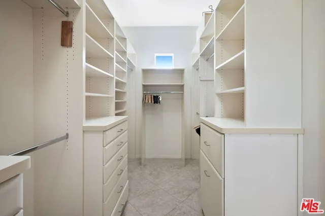 a spacious en suite bathroom with a granite countertop double vanity