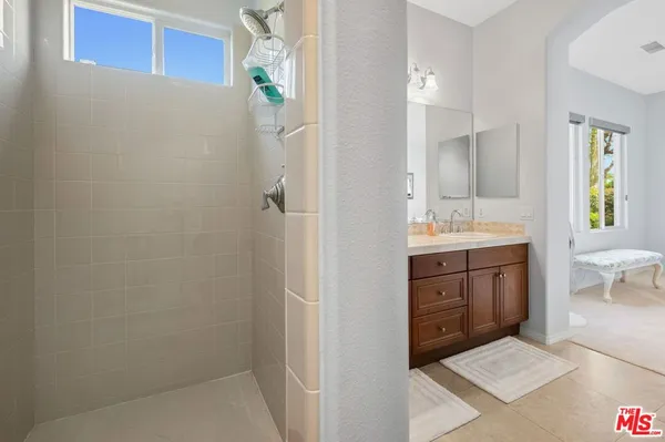 a bathroom with a sink a vanity and a mirror