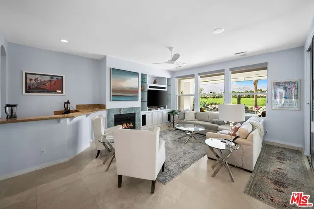 a living room with fireplace furniture and a flat screen tv