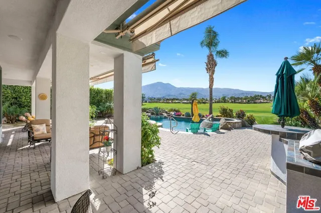 a view of swimming pool and lounge chairs