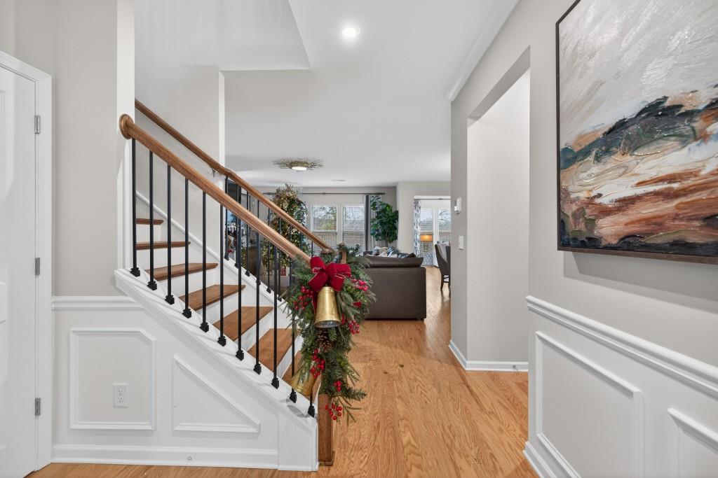 7277 Maple Brook Lane Flowery Branch, GA 30542 - Photo 12 of 93 a view of a hallway with wooden floor and stairs