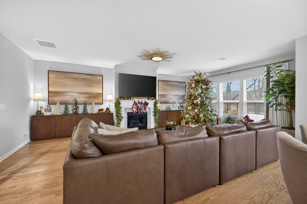 7277 Maple Brook Lane Flowery Branch, GA 30542 - Photo 14 of 93 a living room with furniture and a flat screen tv